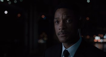 Movie still from “Men in Black 3” (2012), directed by Barry Sonnenfeld – A person wearing a suit and tie; Close Up shot, Over the shoulder angle
