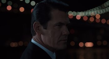 Movie still from “Men in Black 3” (2012), directed by Barry Sonnenfeld – A person wearing a suit and tie; Close Up shot, Over the shoulder angle