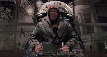 Movie still from “Men in Black 3” (2012), directed by Barry Sonnenfeld – A man in a space suit is holding a pair of wrenches in his hands; Medium shot, Low angle