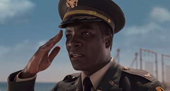 Movie still from “Men in Black 3” (2012), directed by Barry Sonnenfeld – A soldier saluting while saluting another soldier; Close Up shot, Low angle