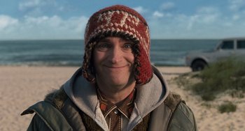 Movie still from “Men in Black 3” (2012), directed by Barry Sonnenfeld – A man wearing a red and white hat on the beach; Close Up shot, Low angle