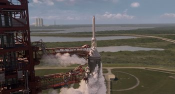 Movie still from “Men in Black 3” (2012), directed by Barry Sonnenfeld – An image of a rocket launching from a launch pad; Extreme Wide shot, Overhead angle
