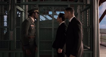 Movie still from “Men in Black 3” (2012), directed by Barry Sonnenfeld – A group of men standing next to each other in suits; Medium shot, Low angle