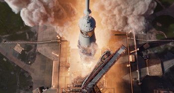 Movie still from “Men in Black 3” (2012), directed by Barry Sonnenfeld – An image of a rocket launch going into the sky; Extreme Wide shot, Overhead angle