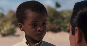 Movie still from “Men in Black 3” (2012), directed by Barry Sonnenfeld – A young boy's face with trees in the background; Close Up shot, Over the shoulder angle