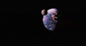 Movie still from “Men in Black II” (2002), directed by Barry Sonnenfeld – An image of an earth and a moon in space; Extreme Wide shot, Low angle
