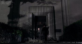 Movie still from “Men in Black II” (2002), directed by Barry Sonnenfeld – A man walking down the side of a door way; Extreme Wide shot, Low angle