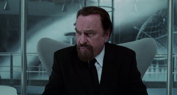 Movie still from “Men in Black II” (2002), directed by Barry Sonnenfeld – A man in a suit and a tie; Close Up shot, Over the shoulder angle