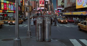 Movie still from “Men in Black II” (2002), directed by Barry Sonnenfeld – A couple of silver gas tanks sitting on the side of a road; Extreme Wide shot, Low angle