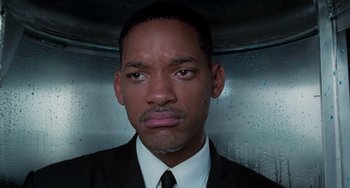 Movie still from “Men in Black II” (2002), directed by Barry Sonnenfeld – A person wearing a suit and tie; Close Up shot, High angle