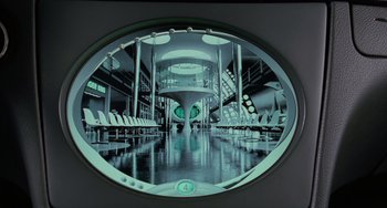 Movie still from “Men in Black II” (2002), directed by Barry Sonnenfeld – A circular mirror in a room with a lot of chairs; Wide shot, High angle