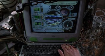 Movie still from “Men in Black II” (2002), directed by Barry Sonnenfeld – A hand is typing on a computer screen; Extreme Close Up shot, Overhead angle