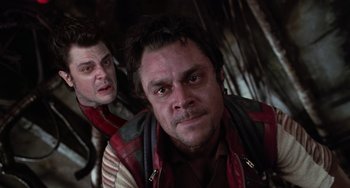 Movie still from “Men in Black II” (2002), directed by Barry Sonnenfeld – Two men are posing for a picture together; Close Up shot, Low angle