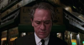 Movie still from “Men in Black II” (2002), directed by Barry Sonnenfeld – A person wearing a suit and tie; Close Up shot, Low angle