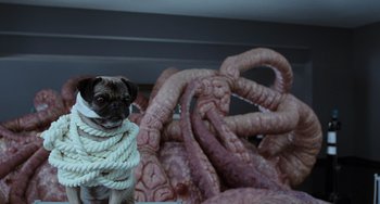 Movie still from “Men in Black II” (2002), directed by Barry Sonnenfeld – A pug dog standing next to a pile of tentacles; Medium shot, Low angle