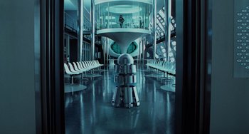 Movie still from “Men in Black II” (2002), directed by Barry Sonnenfeld – A room filled with white chairs and tables; Extreme Wide shot, High angle