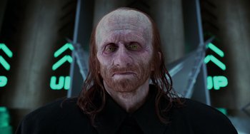 Movie still from “Men in Black II” (2002), directed by Barry Sonnenfeld – An old man with long red hair and green eyes; Close Up shot, Low angle