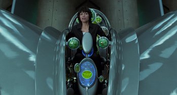Movie still from “Men in Black II” (2002), directed by Barry Sonnenfeld – A woman riding on the back of a scooter; Medium shot, High angle