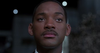 Movie still from “Men in Black II” (2002), directed by Barry Sonnenfeld – Will smith's face in a suit; Close Up shot, Low angle