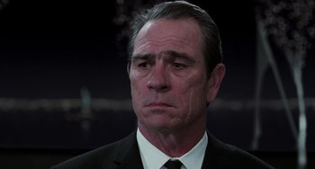 Movie still from “Men in Black II” (2002), directed by Barry Sonnenfeld – An older man in a suit and tie looking sad; Close Up shot, Low angle