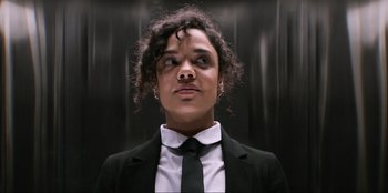 Movie still from “Men in Black: International” (2019), directed by F. Gary Gray – A woman in a suit and tie looking up; Close Up shot, Low angle
