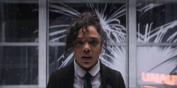 Movie still from “Men in Black: International” (2019), directed by F. Gary Gray – A woman in a black suit and tie; Close Up shot, Low angle