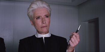 Movie still from “Men in Black: International” (2019), directed by F. Gary Gray – An older woman holding a cell phone up to her ear; Close Up shot, Low angle