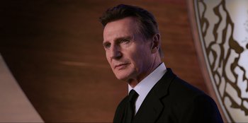 Movie still from “Men in Black: International” (2019), directed by F. Gary Gray – A person wearing a suit and tie; Close Up shot, Low angle