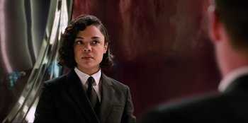 Movie still from “Men in Black: International” (2019), directed by F. Gary Gray – A woman in a suit and tie looking to her left; Medium shot, Over the shoulder angle