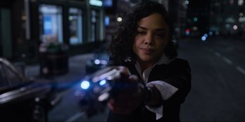 Movie still from “Men in Black: International” (2019), directed by F. Gary Gray – A woman holding a gun in her hand; Medium shot, Over the shoulder angle