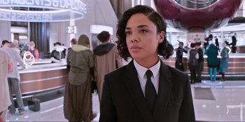 Movie still from “Men in Black: International” (2019), directed by F. Gary Gray – A woman in a suit and a tie; Close Up shot, Over the shoulder angle