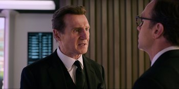 Movie still from “Men in Black: International” (2019), directed by F. Gary Gray – A person wearing a suit and tie; Close Up shot, Over the shoulder angle