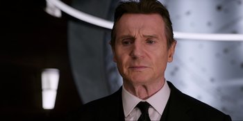 Movie still from “Men in Black: International” (2019), directed by F. Gary Gray – A person wearing a suit and tie; Close Up shot, Over the shoulder angle