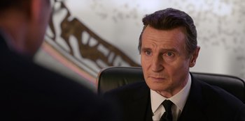 Movie still from “Men in Black: International” (2019), directed by F. Gary Gray – A person wearing a suit and tie; Close Up shot, Over the shoulder angle