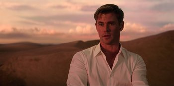 Movie still from “Men in Black: International” (2019), directed by F. Gary Gray – A person wearing a white shirt; Medium shot, Over the shoulder angle