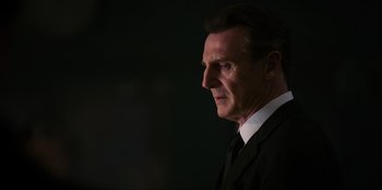 Movie still from “Men in Black: International” (2019), directed by F. Gary Gray – A person wearing a suit and tie; Close Up shot, Low angle