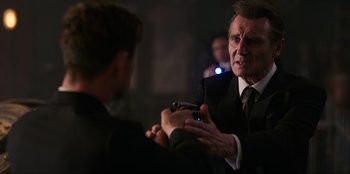 Movie still from “Men in Black: International” (2019), directed by F. Gary Gray – A man in a suit and tie holding another man's hand; Close Up shot, Over the shoulder angle
