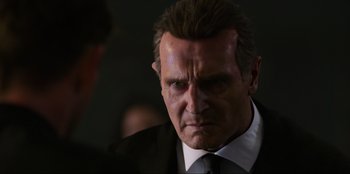 Movie still from “Men in Black: International” (2019), directed by F. Gary Gray – A person wearing a suit and tie; Close Up shot, Over the shoulder angle