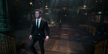 Movie still from “Men in Black: International” (2019), directed by F. Gary Gray – A man in a black suit and a man in a black suit; Wide shot, Low angle