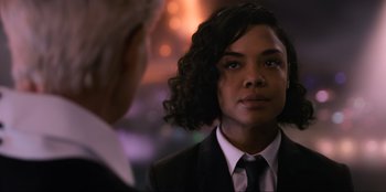 Movie still from “Men in Black: International” (2019), directed by F. Gary Gray – A woman in a suit and a tie; Close Up shot, Over the shoulder angle