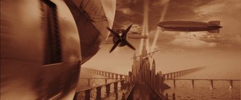 Movie still from “Midway” (2019), directed by Roland Emmerich – An artistic picture of a castle and a bridge with planes flying over it; Extreme Wide shot, Low angle