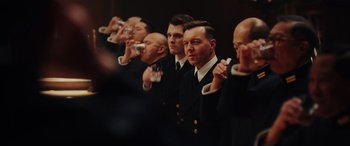 Movie still from “Midway” (2019), directed by Roland Emmerich – A group of men standing next to each other holding drinks; Close Up shot, Over the shoulder angle