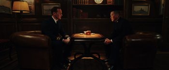 Movie still from “Midway” (2019), directed by Roland Emmerich – Two men sitting at a table in front of each other; Medium shot, Low angle