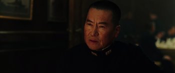 Movie still from “Midway” (2019), directed by Roland Emmerich – An older man wearing a black military uniform; Close Up shot, Over the shoulder angle