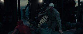 Movie still from “Midway” (2019), directed by Roland Emmerich – A man with a bandage on his head is climbing stairs; Medium shot, High angle