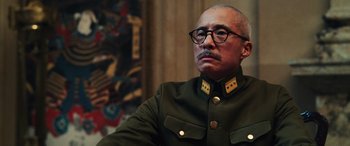 Movie still from “Midway” (2019), directed by Roland Emmerich – An older man in a military uniform looking off into the distance; Close Up shot, Low angle