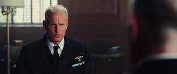 Movie still from “Midway” (2019), directed by Roland Emmerich – A man in a suit and tie; Close Up shot, Low angle