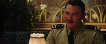 Movie still from “Midway” (2019), directed by Roland Emmerich – A person sitting at a table wearing a uniform; Close Up shot, Over the shoulder angle