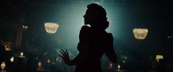 Movie still from “Midway” (2019), directed by Roland Emmerich – The silhouette of a woman in a dark room; Medium shot, Low angle