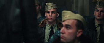 Movie still from “Midway” (2019), directed by Roland Emmerich – A man in a military uniform is looking at the camera; Close Up shot, Low angle